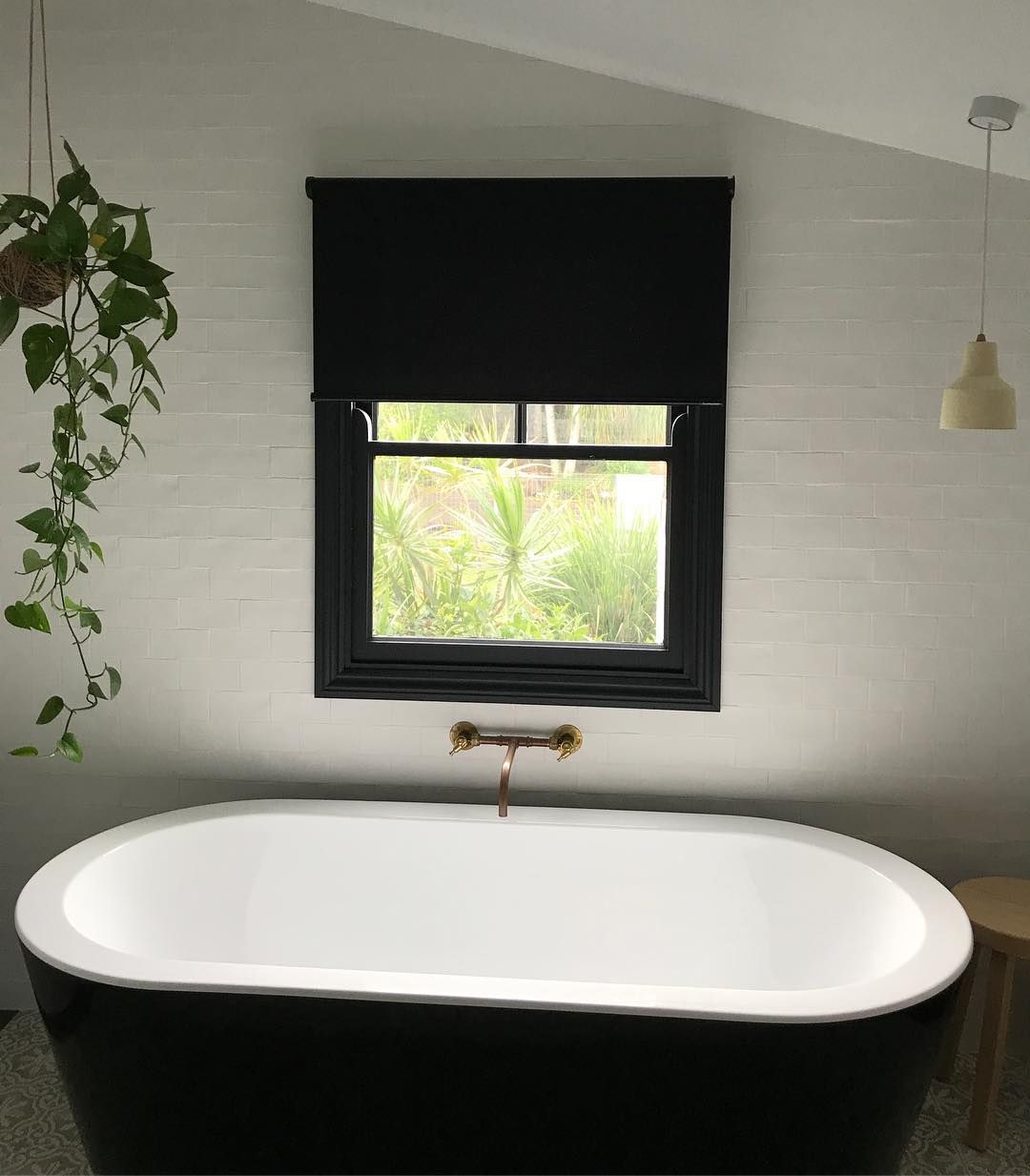 Black Bathtub Under a Window With Black Shade. Hanging Plant on the Left — BlindDESIGN in Byron Bay, NSW