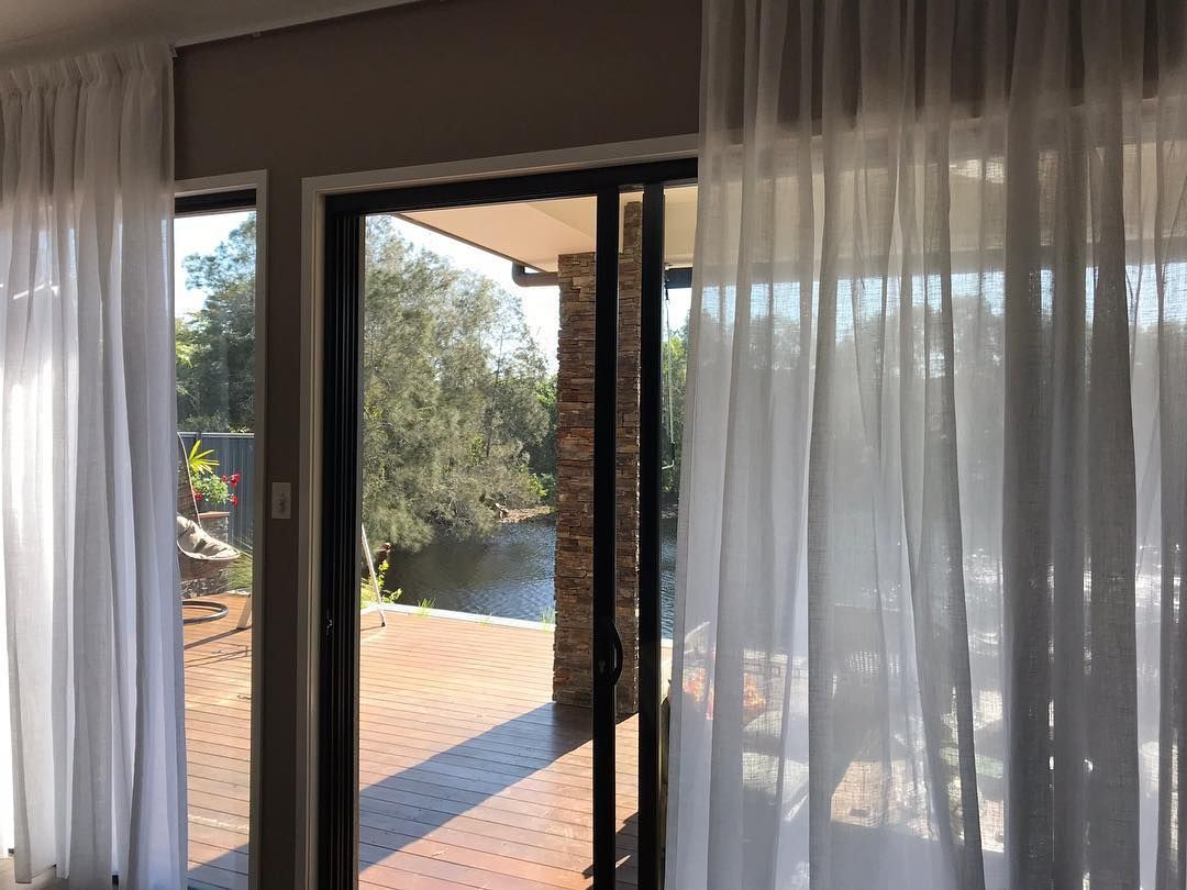 White Sheer Curtains Frame a Sliding Glass Door — BlindDESIGN in Ballina, NSW