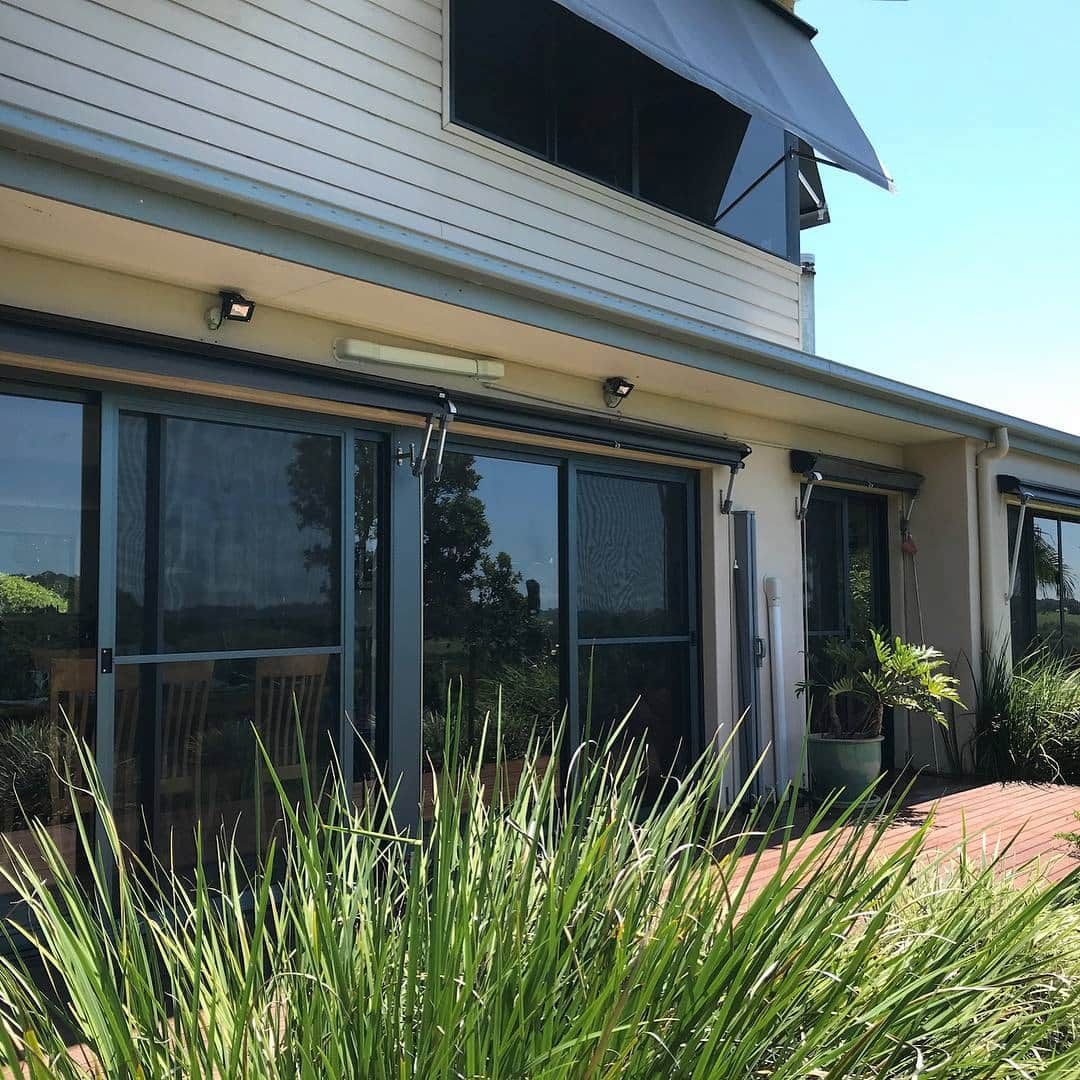 Two-story Building With Dark Window Coverings — BlindDESIGN in Byron Bay, NSW