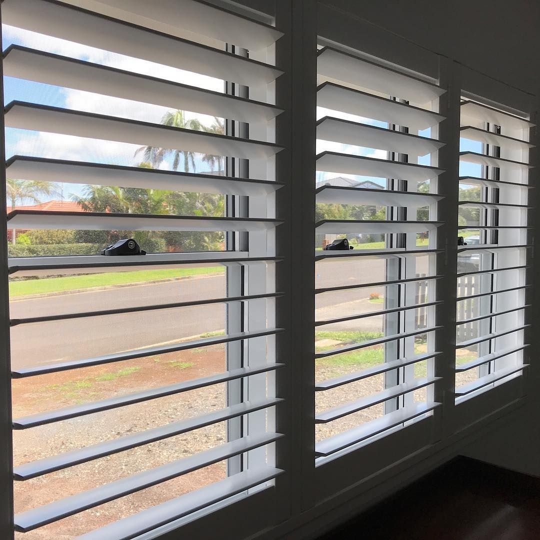 White Plantation Shutters on A Window, Partially Open — BlindDESIGN in Byron Bay, NSW