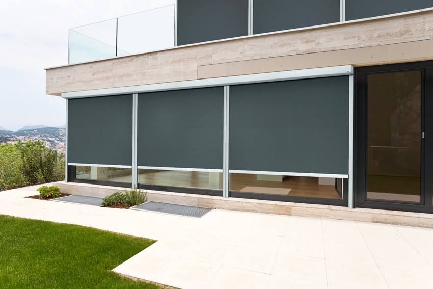 Exterior of a Modern Home With Grey Shades Over Large Windows — BlindDESIGN in Byron Bay, NSW