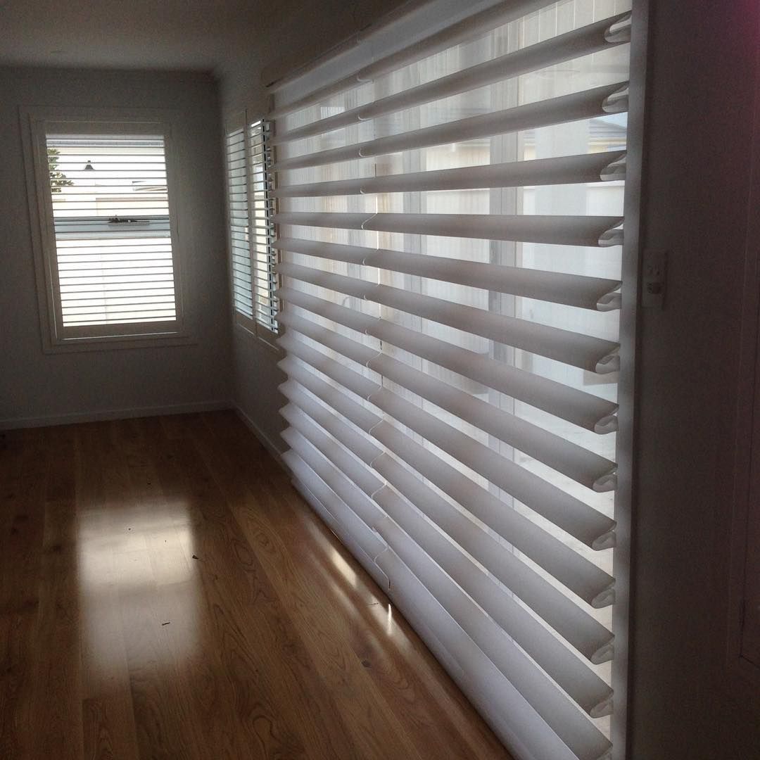 Room With Wood Floor and Large Window Featuring Layered Blinds — BlindDESIGN in Byron Bay, NSW