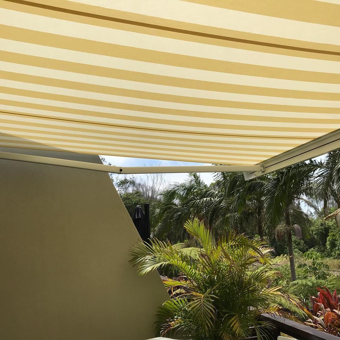Green and White Striped Awning Shading a Balcony Overlooking Trees and Lawn — BlindDESIGN in Lennox Head, NSW