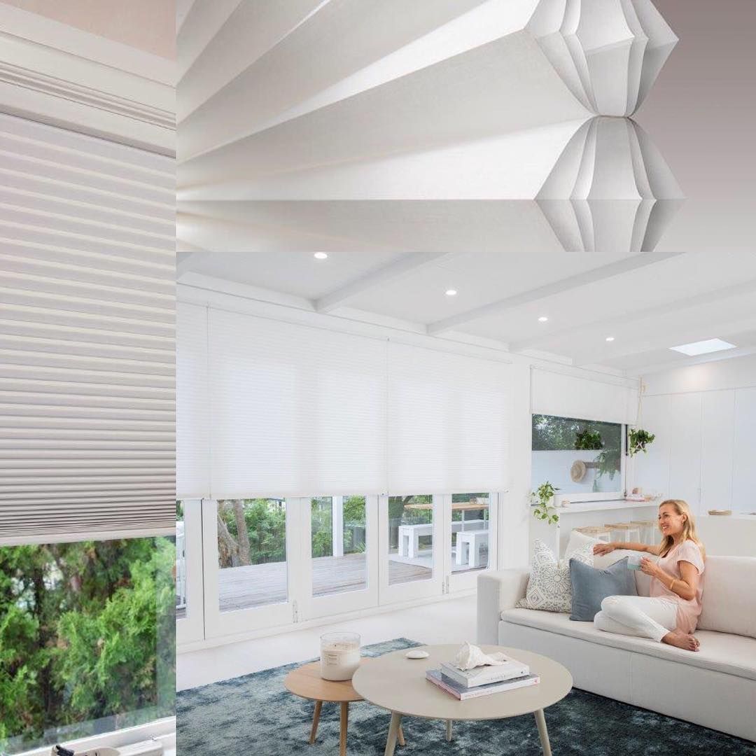A Bright Living Room With White Blinds, Sofa, and a Woman Sitting — BlindDESIGN in Lennox Head, NSW