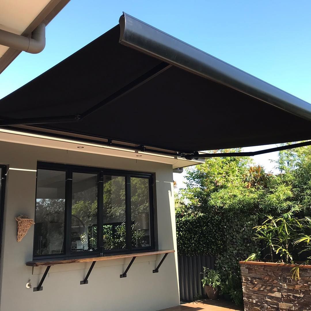 Black Retractable Awning Over a Window With a Wooden Counter — BlindDESIGN in Mullumbimby, NSW