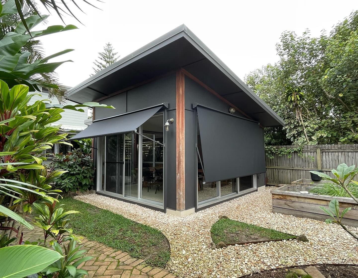 Modern Black Shed with Angled Roof, Glass Windows, and Awnings — BlindDESIGN in Mullumbimby, NSW