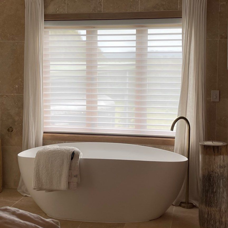 White Bathtub in a Bright Bathroom, Sheer Window Blinds, and Curtains — BlindDESIGN in Byron Bay, NSW