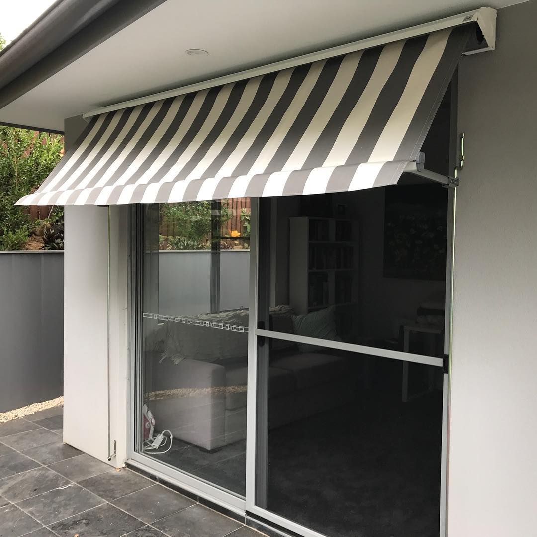 Striped Awning Shades a Glass Door on a Patio — BlindDESIGN in Byron Bay, NSW