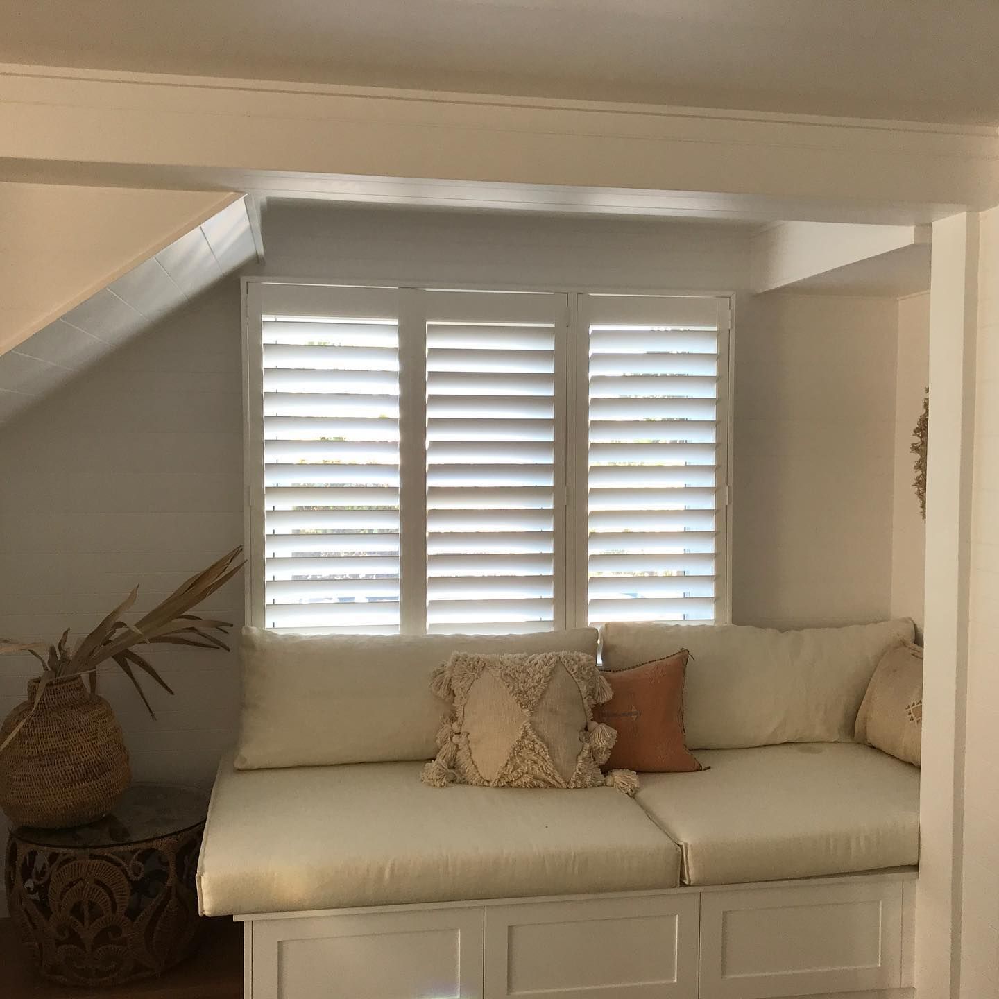 Cozy Window Seat With White Shutters, Cream Cushions, and Decorative Pillows — BlindDESIGN in Byron Bay, NSW