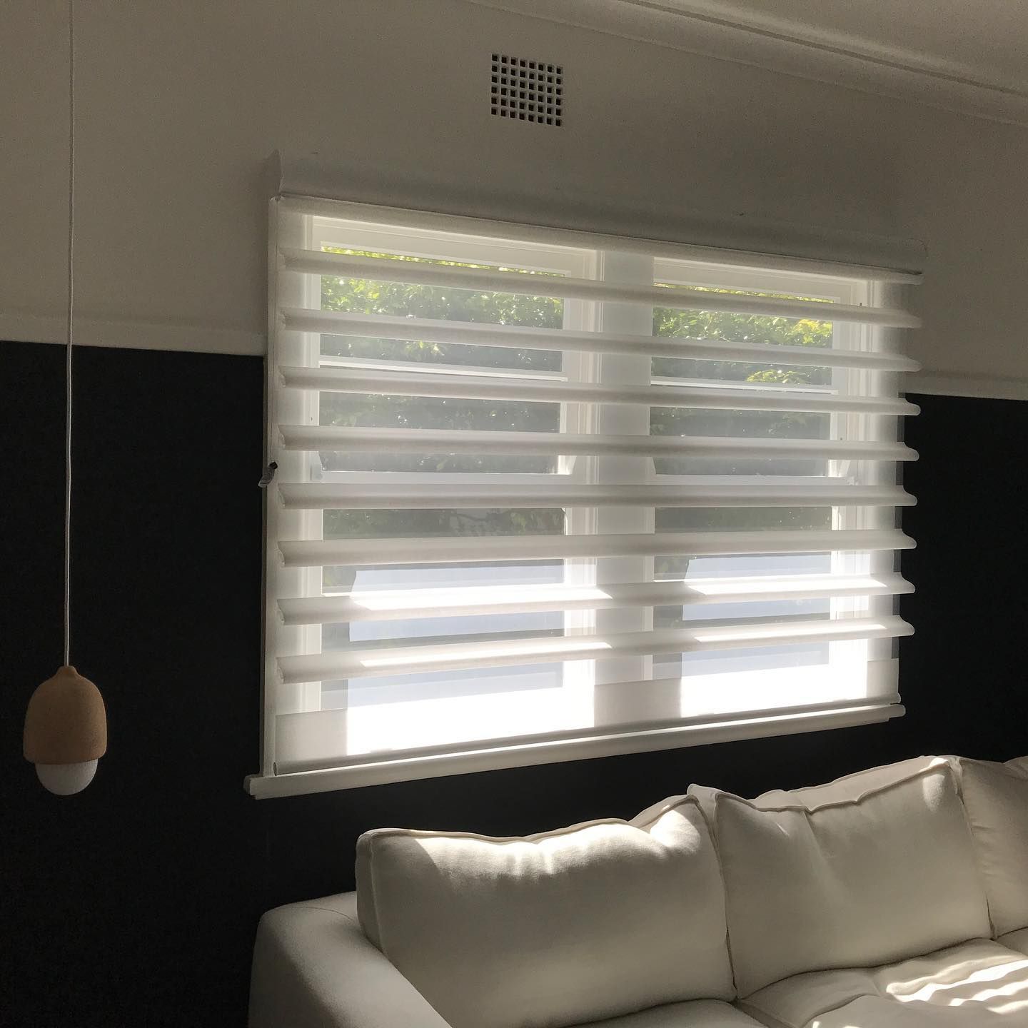 White Layered Window Blinds Over a Window, Above a White Couch — BlindDESIGN in Byron Bay, NSW