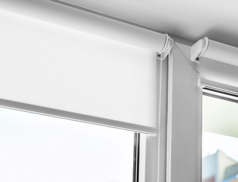 White Roller Blinds Partially Covering a Window, with A Visible Pull Cord — BlindDESIGN in Byron Bay, NSW