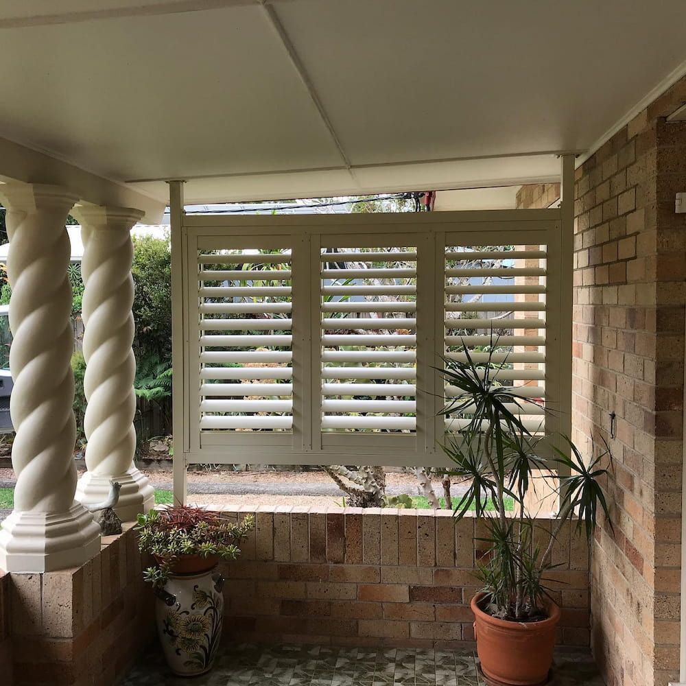Covered Porch With Beige Shutters and Spiral Columns — BlindDESIGN in Lennox Head, NSW