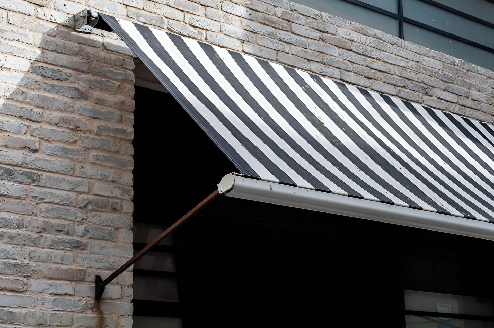 Black and White Striped Awning Over a Window — BlindDESIGN in Byron Bay, NSW