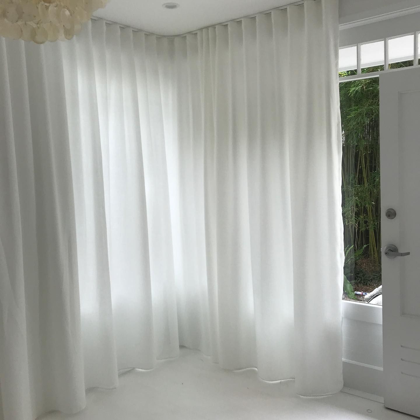 White Curtains Hanging in a White Room, Next to a White Doorway With a View of Greenery — BlindDESIGN in Mullumbimby, NSW