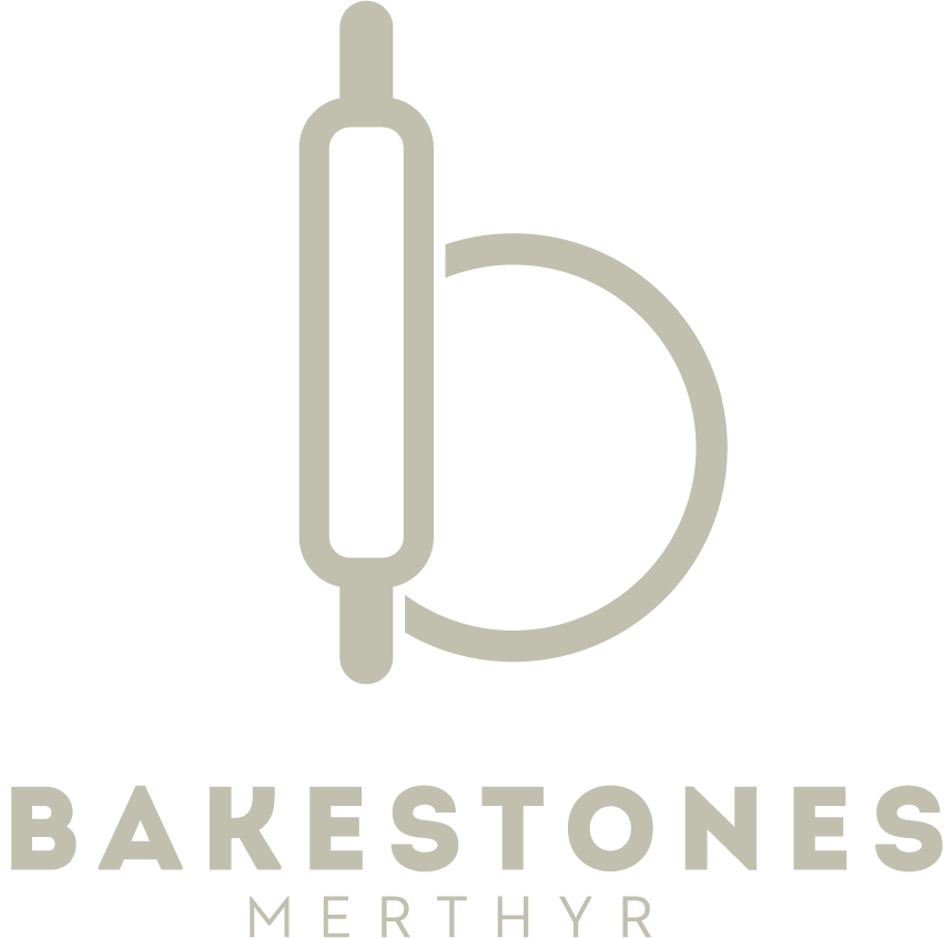 Bakestone Wales | The logo for bakestones merthyr is a rolling pin in the shape of a letter b.