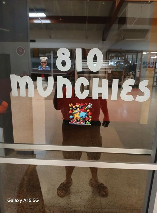 Person reflected in glass door of 