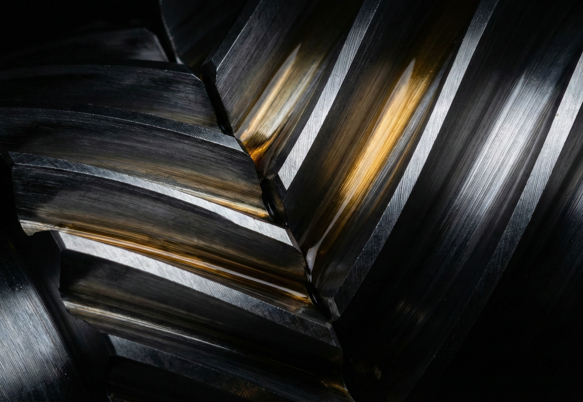 Close-up of interlocking metal gears, showing metallic sheen and rust-colored stains.