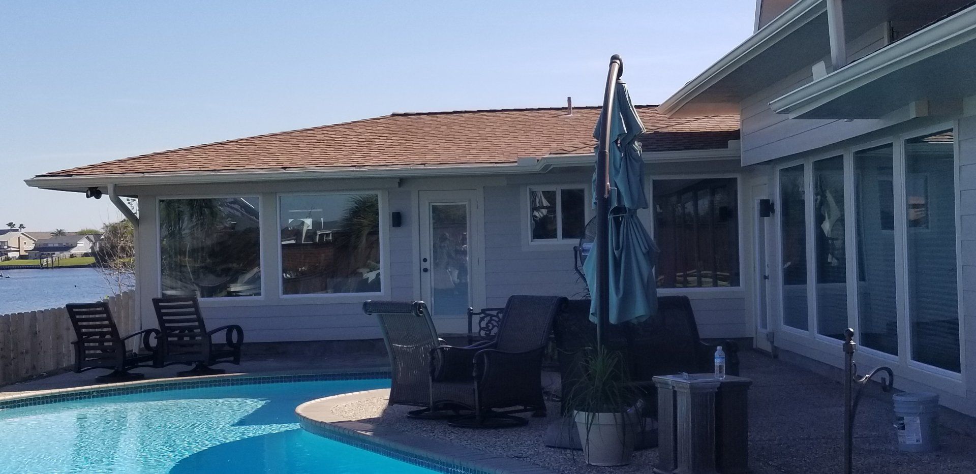 A large house with a swimming pool in front of it.