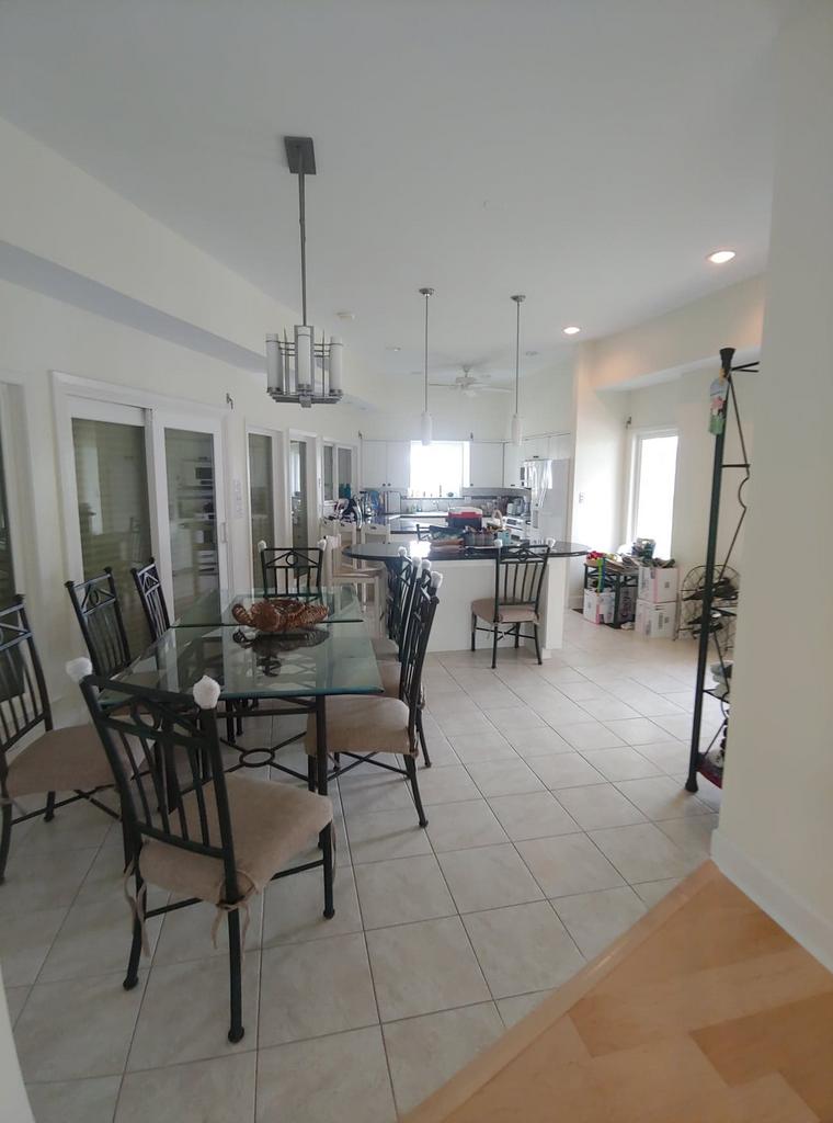 A large dining room with a glass table and chairs