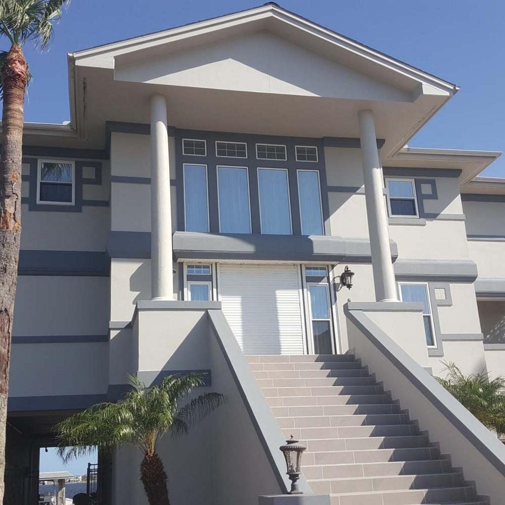 A large white house with stairs leading up to it