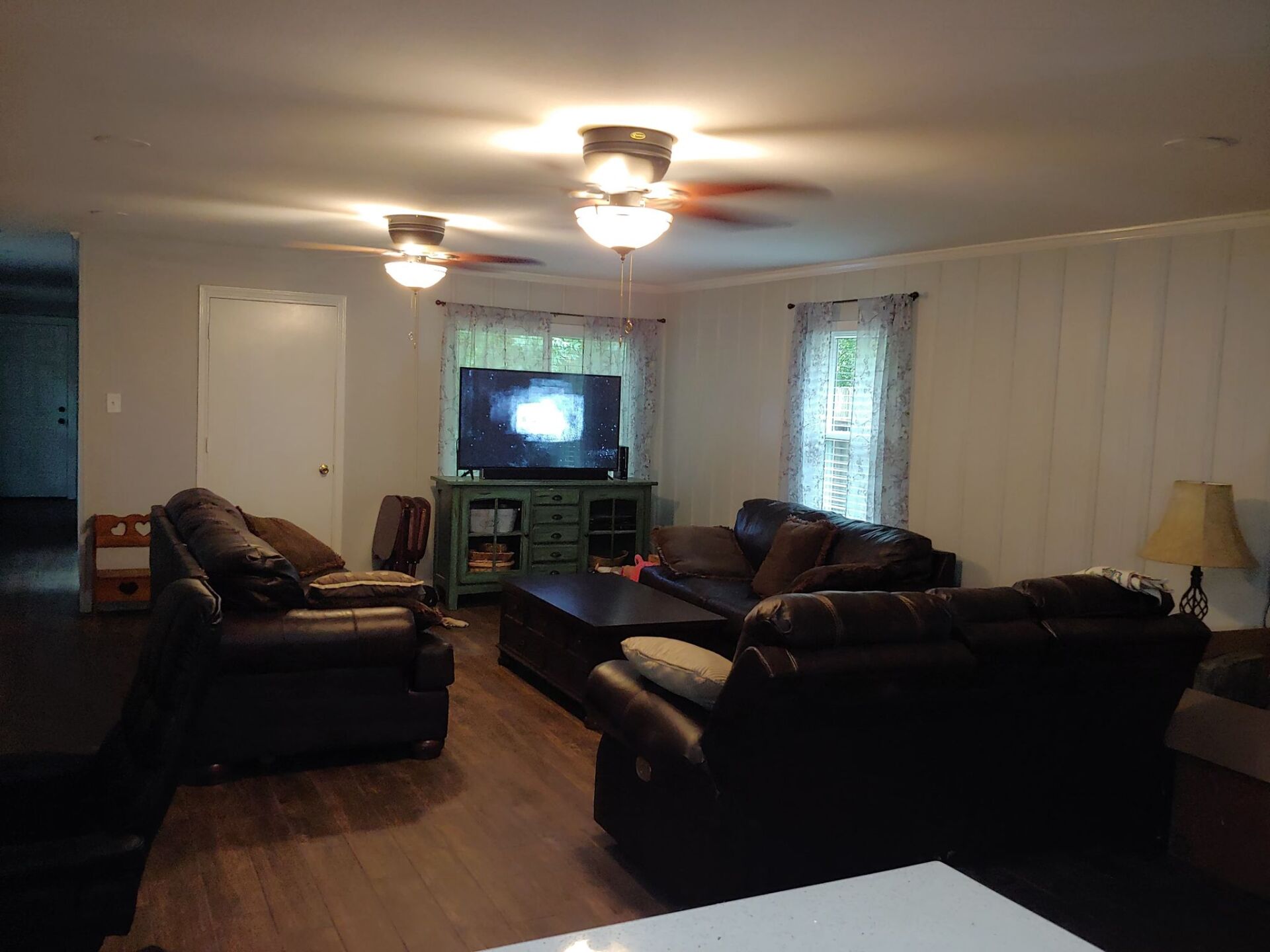 A living room filled with furniture and a flat screen tv.