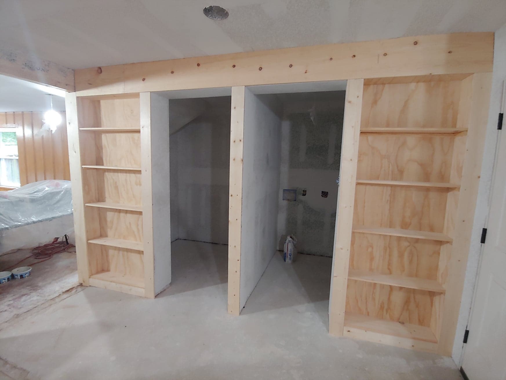 A room with a lot of shelves and doors in it