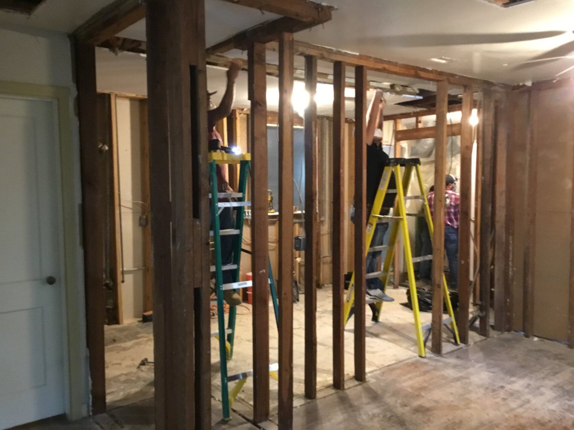 A group of people are working on a house.