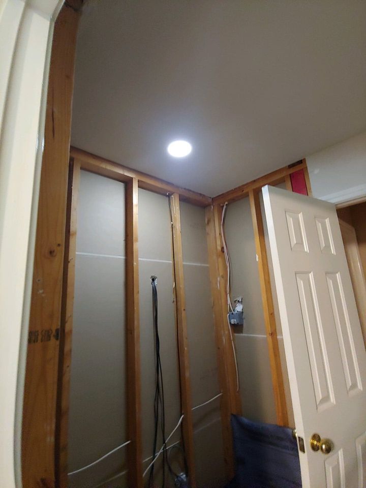 A room with a door and a light on the ceiling.