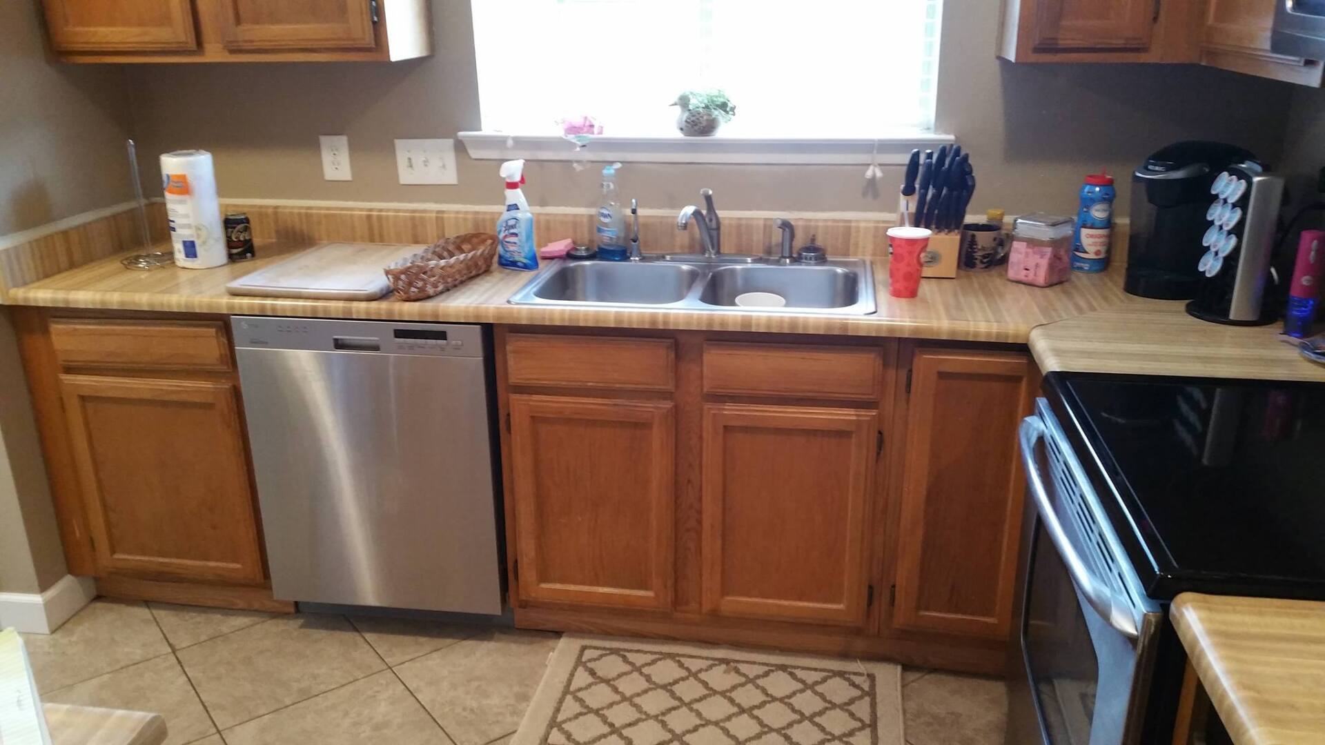 A kitchen with stainless steel appliances and wooden cabinets.