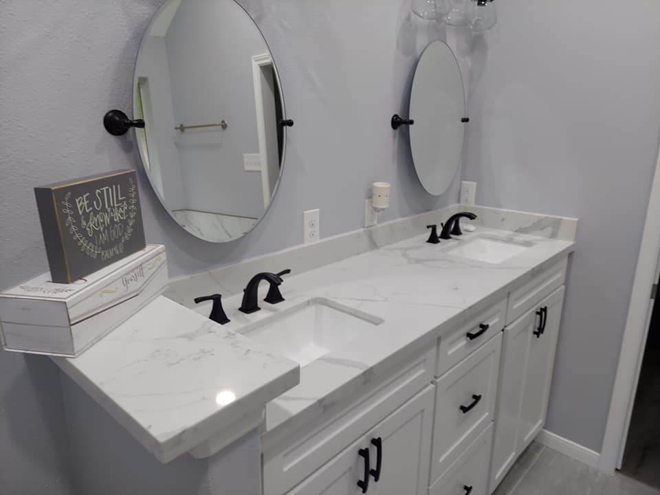 A bathroom with two sinks and two mirrors.