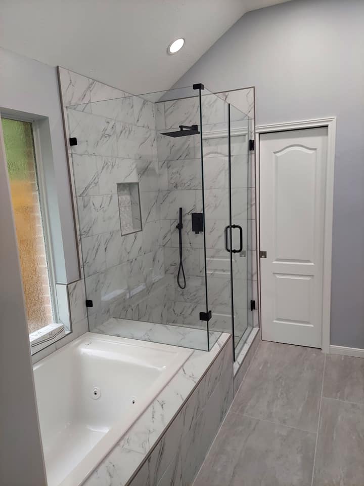 A bathroom with a bathtub and a walk in shower.