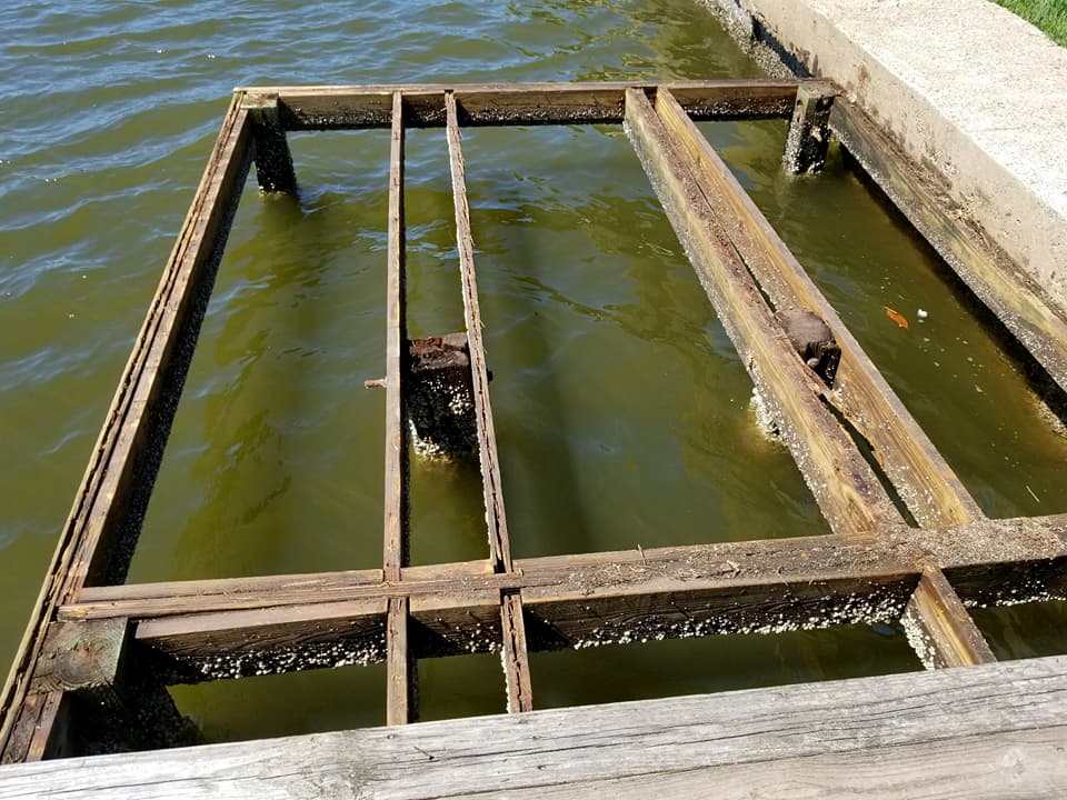 A wooden structure is sitting in the middle of a body of water.