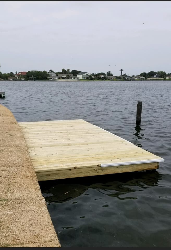 A wooden dock is in the middle of a lake
