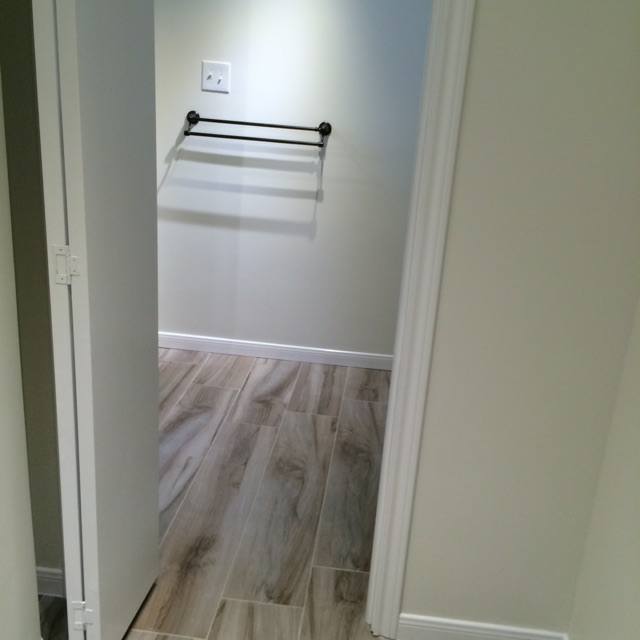 A hallway with a towel rack on the wall