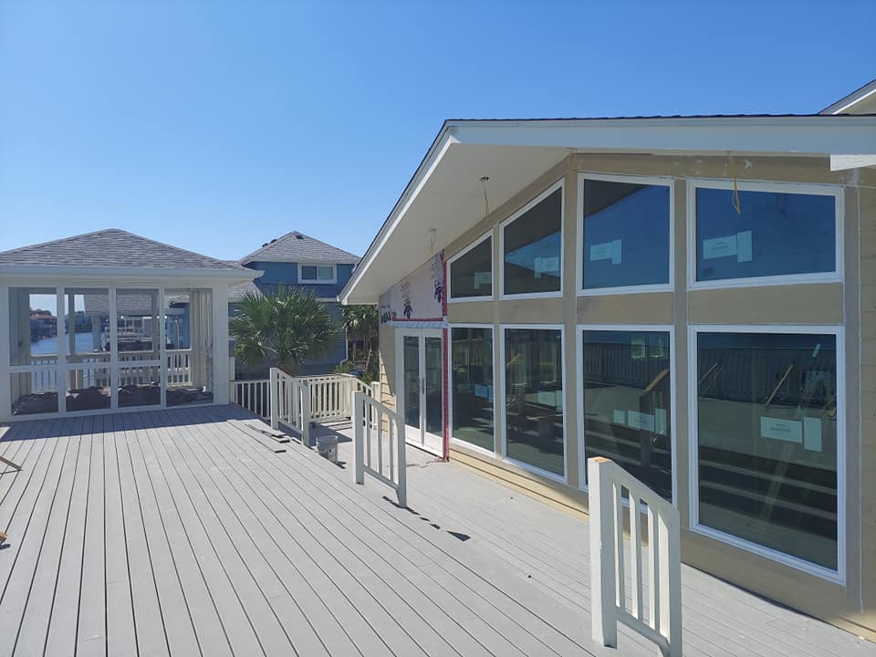 A house with a large deck and lots of windows