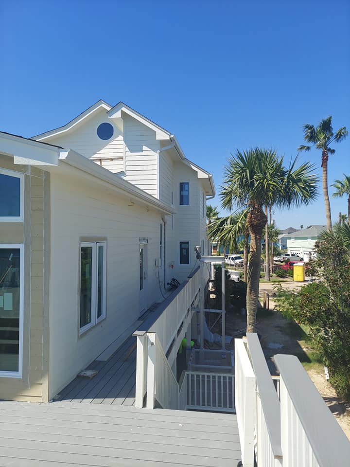 A white house with palm trees in front of it