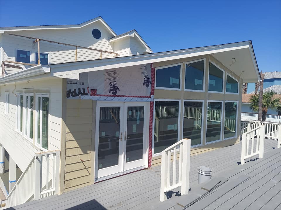 A house with a lot of windows is being remodeled