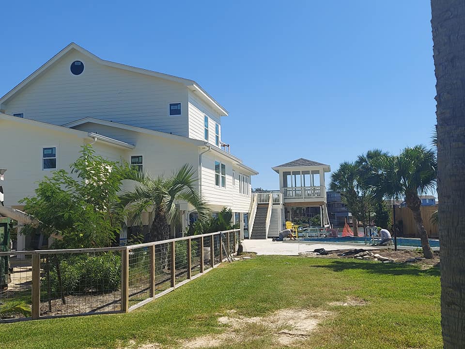 A large white house with a pool in the backyard