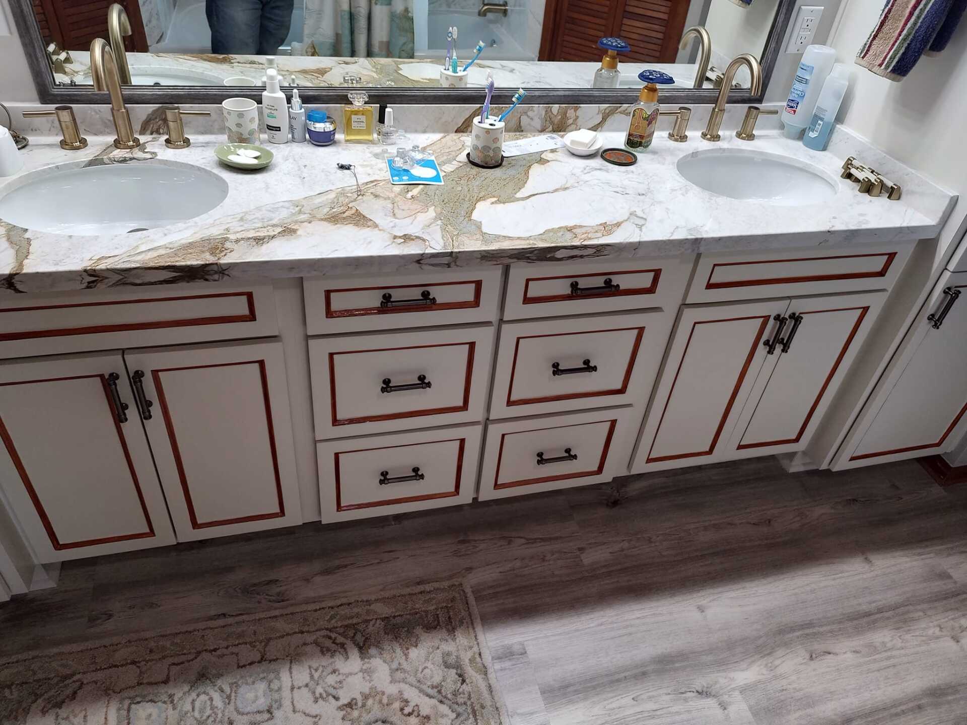 A bathroom with two sinks and a mirror.