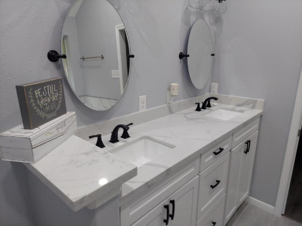 A bathroom with two sinks and two mirrors.
