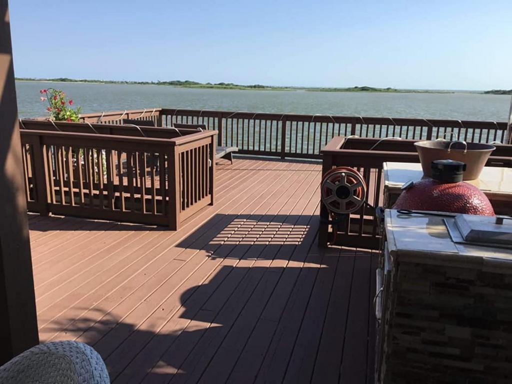 A large wooden deck overlooking a body of water