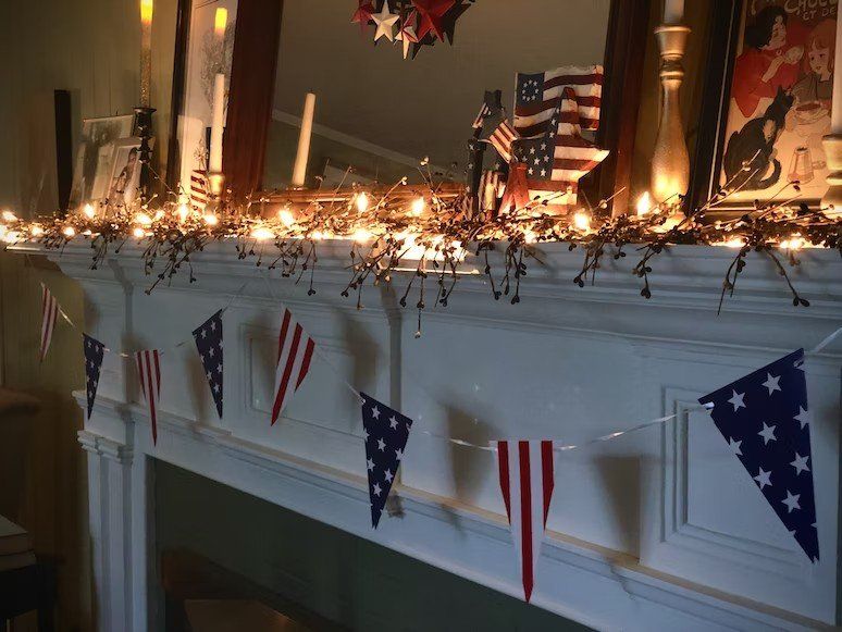 A mantle with american flags and lights on it