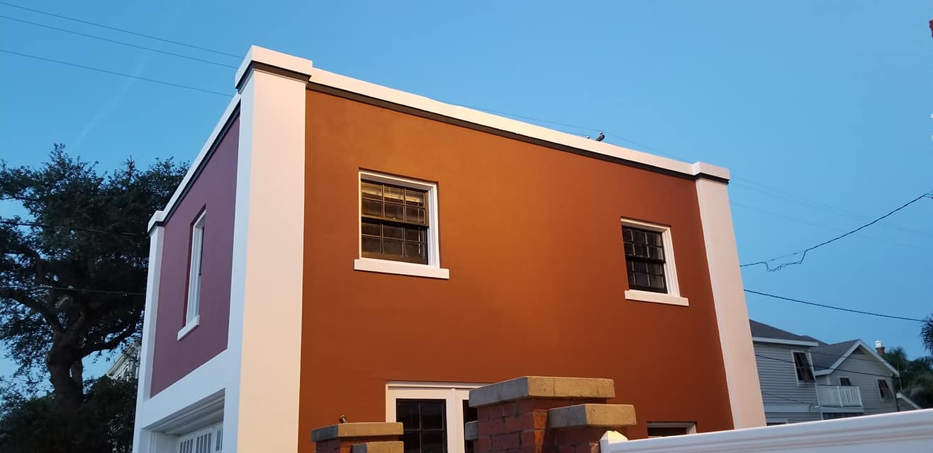 A brown and white building with a blue sky in the background