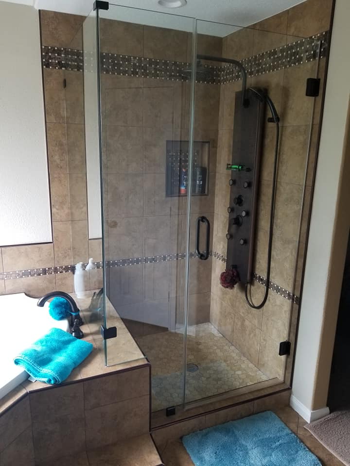 A bathroom with a walk in shower and a bathtub.