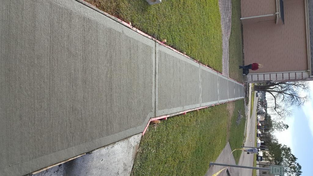 A sidewalk is being built in front of a building