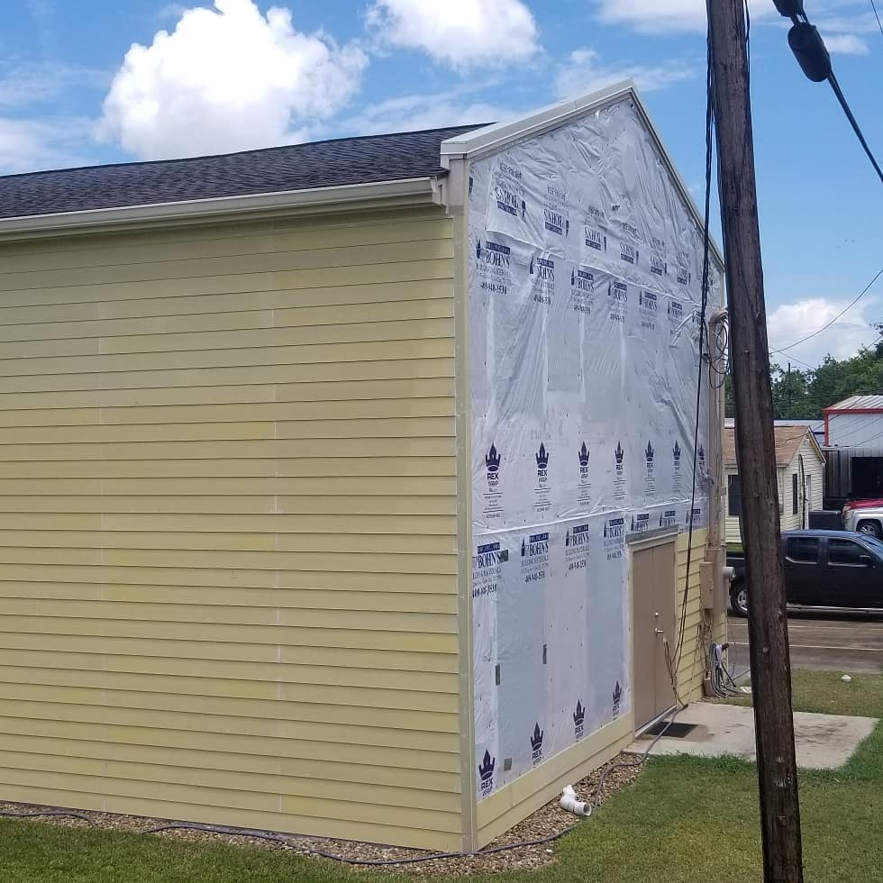A building with a lot of siding on it is being remodeled.