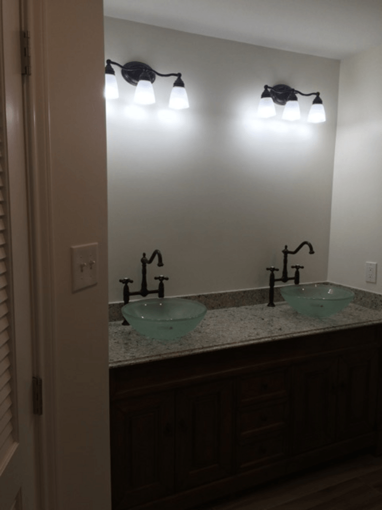 A bathroom with two sinks and a mirror.