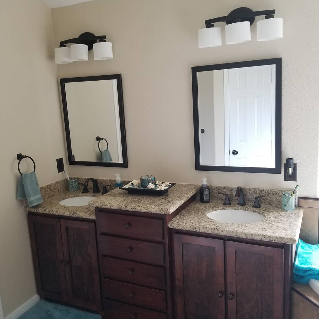 A bathroom with two sinks and two mirrors