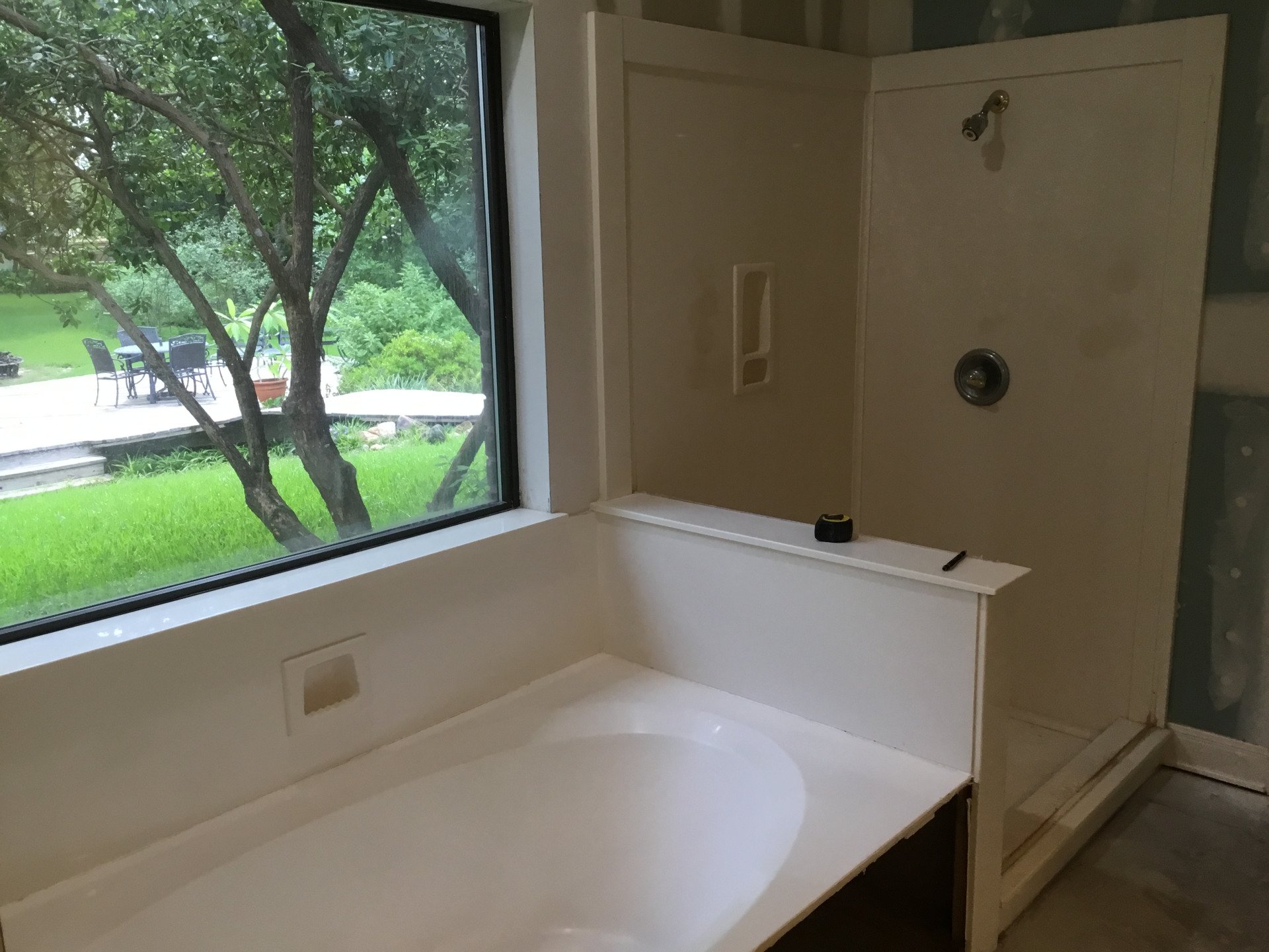 A bathroom with a bathtub and a shower.