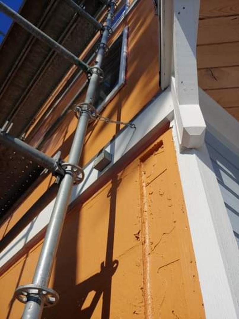 A scaffolding is attached to the side of a building